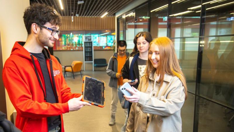 students signing in for an event in a university building